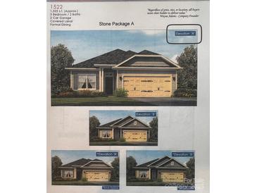 An elevation view showing a charming one-story home with a two-car garage and stone facade at 713 Inwood Hill Dr # 96, Gastonia, NC 28056