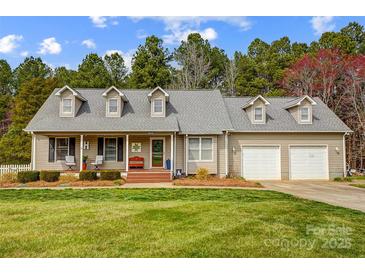 Charming single-Gathering home featuring a well-manicured lawn, attached two-car garage, and a welcoming covered front porch at 1625 Saint Paul Church Rd, Salisbury, NC 28146