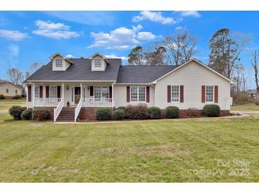Charming home featuring a well-manicured lawn, inviting porch, and classic architectural details at 207 Silver Creek Ln, Shelby, NC 28152