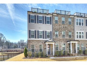 Modern townhome with brick facade, shutters, and rooftop deck at 208 Emerson Ave, Charlotte, NC 28204