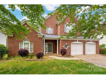 Charming two-story brick home with a well-manicured lawn, a two-car garage, and a welcoming entrance at 4036 Sawmill Trace Dr, Charlotte, NC 28213