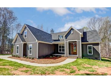 Charming home featuring a modern exterior, manicured lawn and mulched garden bed at 4262 Brandy Creek Ct, Clover, SC 29710