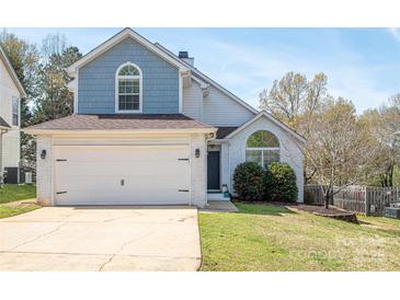 Charming two-story home featuring a two-car garage, blue accents, and well-maintained landscaping at 7343 Rock Island Rd, Charlotte, NC 28278