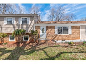 Charming brick home featuring a welcoming front entrance with decorative door and manicured landscaping at 809 E 23Rd Street St, Newton, NC 28658
