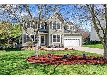 Charming two-story home with a well-manicured lawn, beautiful landscaping, and a two-car garage at 8511 Fox Tail Ln, Huntersville, NC 28078