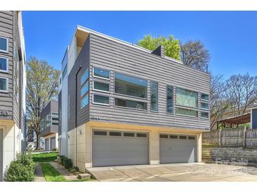 Modern home featuring a two-car garage and a stylish horizontal plank exterior with large windows at 914 Greenleaf Ave # A, Charlotte, NC 28202