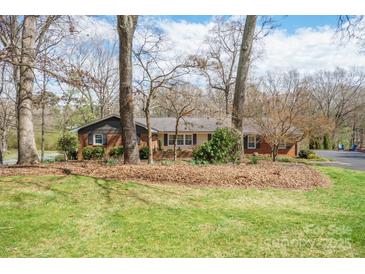 Charming brick home with a well-maintained front yard and mature trees provides great curb appeal at 101 Woodvale Cir, Lincolnton, NC 28092