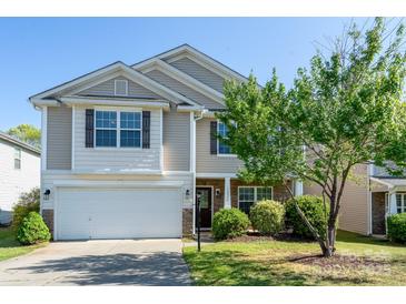 Charming two-story home with a manicured lawn, attached garage, and inviting front entrance at 12915 Settlers Trail Ct, Charlotte, NC 28278