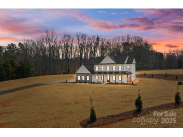 Beautiful two-story modern farmhouse-style home with a landscaped front yard and inviting front porch at 1695 Agner Rd, Salisbury, NC 28146