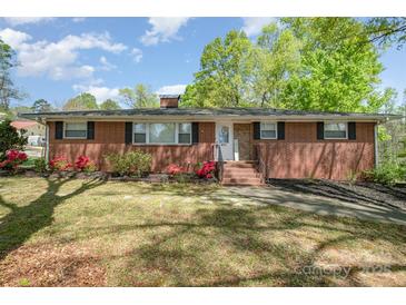 Charming brick home with landscaped front yard and inviting entrance, perfect for curb appeal at 401 Dakota St, Kannapolis, NC 28083