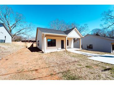 Charming single-story home featuring a covered porch and a neatly maintained front yard at 945 3Rd Street Sw Pl, Hickory, NC 28602