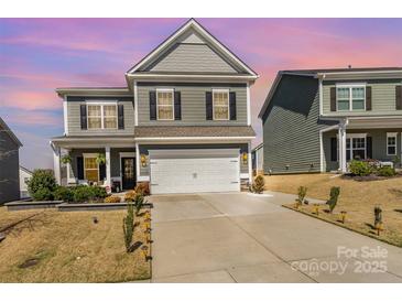 Charming two-story home with a two-car garage and manicured landscaping at 123 Clauser N Rd, Mount Holly, NC 28120