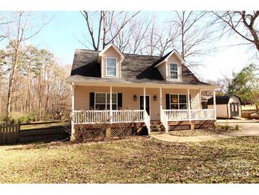 Charming home with a welcoming front porch, dormer windows and manicured lawn on a sunny day at 1256 Twin Lakes Rd, Rock Hill, SC 29732