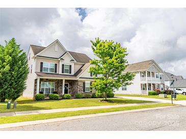 Charming two-story home with stone accents, manicured lawn and beautiful curb appeal at 128 Millen Dr, Mooresville, NC 28115