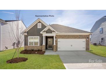 Charming single Gathering home featuring a two-car garage, stone accents, and manicured lawn at 2315 Riggs Rd, Sherrills Ford, NC 28673