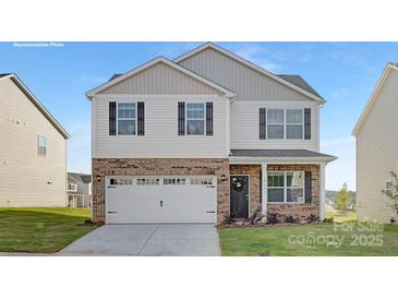 Charming two-story home with white siding, brick accents, black shutters, and a spacious two-car garage at 2319 Riggs Rd, Sherrills Ford, NC 28673