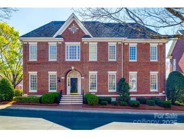 Charming brick home featuring multi-pane windows, elegant arched entryway, and manicured landscaping at 2622 Sheffield Crescent Ct, Charlotte, NC 28226