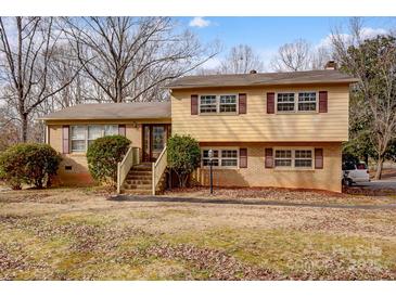 Charming two-story home with a brick and vinyl facade, complemented by well-maintained landscaping at 1142 Canterbury Dr, Lancaster, SC 29720