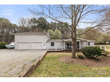 Charming single Gathering home featuring a covered front porch, a large lot and separate 2-car garage at 117 Pine Bluff Dr, Mooresville, NC 28117