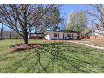 Spacious front yard with a well-maintained lawn, mature trees, and inviting home creating a welcoming atmosphere at 324 East End S Ave, Statesville, NC 28677
