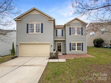 Charming two-story home with gray siding, blue shutters, and a large garage at 722 Ladino Ln, Clover, SC 29710