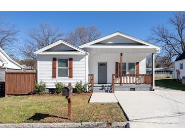 Charming home with a covered porch, complemented by brown shutters and a well-maintained front yard at 1305 Price Ave, Kannapolis, NC 28081