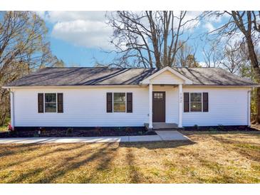 Charming single-story home featuring white siding, a dark roof, and well-maintained front yard landscaping at 132 Shady Grove Rd, Kings Mountain, NC 28086