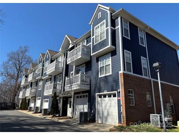 Beautiful townhome row showcasing private balconies and attached garages at 1634 Walnut View Dr, Charlotte, NC 28208