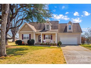 Inviting single-Gathering home with a well-manicured lawn and charming curb appeal on a sunny day at 655 Mock Mill Rd, Statesville, NC 28677