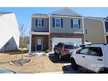 Two-story home with stone accents, gray siding, and a well-maintained front lawn at 8112 Clairwood Dr, Charlotte, NC 28269