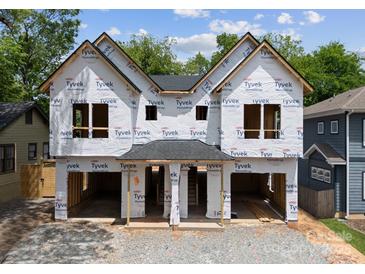 Exterior view of a new construction home, showcasing its framing and initial stages of completion at 1411 Downs Ave, Charlotte, NC 28205
