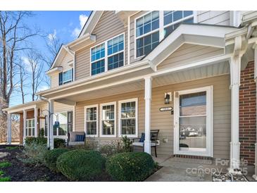 Charming front porch featuring cozy seating and a well-maintained landscape at 154 Limerick Rd # D, Mooresville, NC 28115