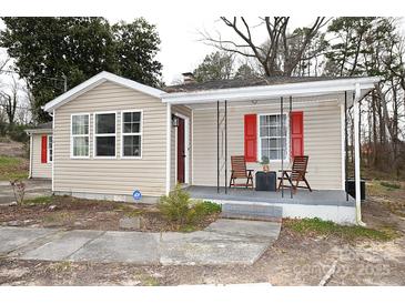 Charming single-story home with vinyl siding, front porch with seating, and red shutters at 2010 Simmons St, Gaston, NC 28052