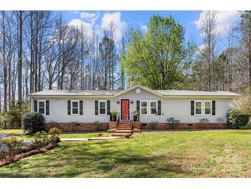 Charming single-story home with a brick foundation, red front door, black shutters, and a well-manicured lawn at 230 Valley View Dr, Clover, SC 29710