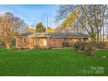 Charming brick home with a lush green lawn and mature trees in a quiet neighborhood at 2750 Morgan Rd, Gold Hill, NC 28071