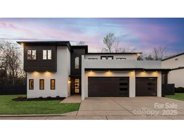 Stunning modern home with a sleek black and white design and a spacious three-car garage at 2924 Springs Dr, Charlotte, NC 28226