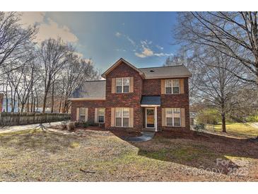 Charming two-story brick home with well-manicured lawn and mature trees at 2013 Barkley Cir, Monroe, NC 28112