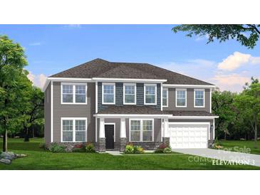 Charming two-story home with a gray exterior, a landscaped yard, a two-car garage, and a covered front porch at 215 Supernova Dr # 25, York, SC 29745