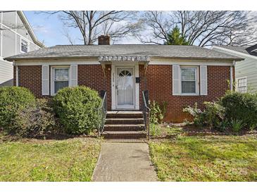 Charming brick home featuring a welcoming front door with glass panel and a manicured front yard at 2309 Shenandoah Ave, Charlotte, NC 28205