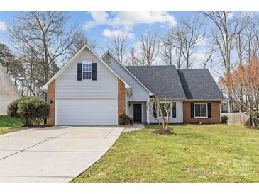 Charming home featuring a two-car garage, brick accents, and a well-manicured lawn at 3919 Chatterleigh Dr, Monroe, NC 28110