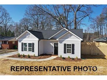 Charming single-story home featuring black roof, black shutters, and manicured lawn at 942 Saturn St, Gastonia, NC 28052