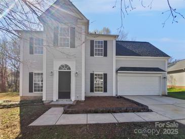 Charming two-story home with black shutters, a two-car garage, and landscaped front yard at 9832 Veronica Dr, Charlotte, NC 28215