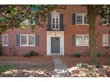 Charming brick building featuring a classic front door entrance and Juliet balcony at 103 S Laurel Ave, Charlotte, NC 28207