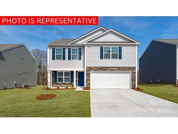 Charming two-story home boasting a well-manicured lawn and a classic facade in a tranquil neighborhood at 117 Way Cross Ln, Troutman, NC 28166