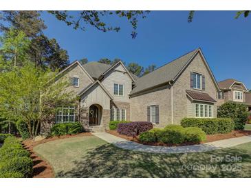Charming brick home features a manicured lawn, walkway, and tasteful landscaping at 17733 Colleton River Ln, Charlotte, NC 28278