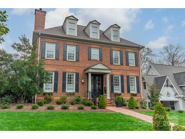 Beautiful brick home with a manicured lawn, black shutters, and a charming entrance at 1801 Maryland Ave, Charlotte, NC 28209