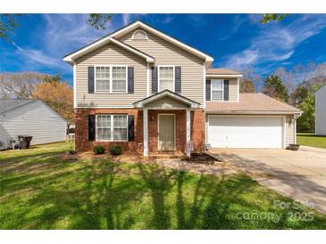 Charming two-story home with a combination of brick and siding, set against a vibrant blue sky at 1812 Rosewell Dr, Rock Hill, SC 29732