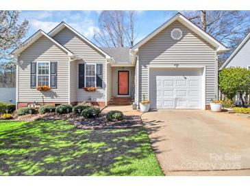 Charming home featuring well-maintained landscaping, a red front door, and a one car garage at 2318 Kestrel Dr, Rock Hill, SC 29732