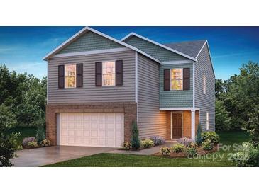 Charming two-story home with a two-car garage, brick accents and professionally landscaped front yard at 3736 13Th Ne St, Hickory, NC 28601