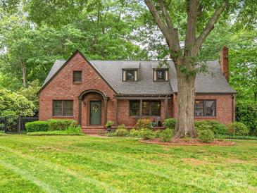 Charming brick home featuring a well-manicured lawn and mature trees at 600 S Central Ave, Belmont, NC 28012